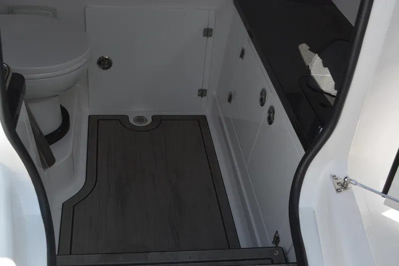 Slide: The Image of Interior of 2026 Monterey Elite 27 OB boat, featuring a compact bathroom with modern fixtures. - 25