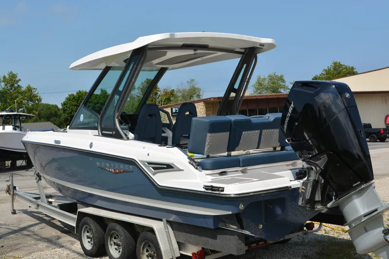 Slide: The Image of 2026 Monterey Elite 27 OB boat on trailer, featuring sleek design and powerful outboard motor. - 3