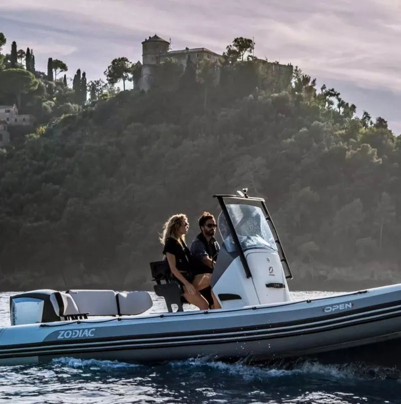 Slide: The Image of 2024 Zodiac Open 7 boat cruising near scenic coastline. - 1