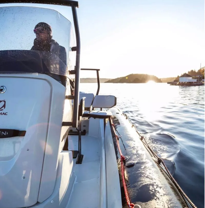Slide: The Image of Zodiac Open 7 2024 on calm waters at sunset. - 2