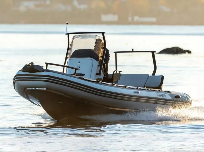 Slide: The Image of 2024 Zodiac Open 7 boat cruising on calm water. - 3