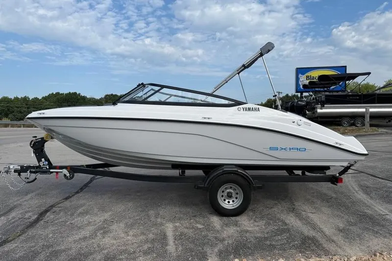 The Image of 2026 Yamaha Boats SX190 on trailer, parked outdoors under a blue sky. - 0