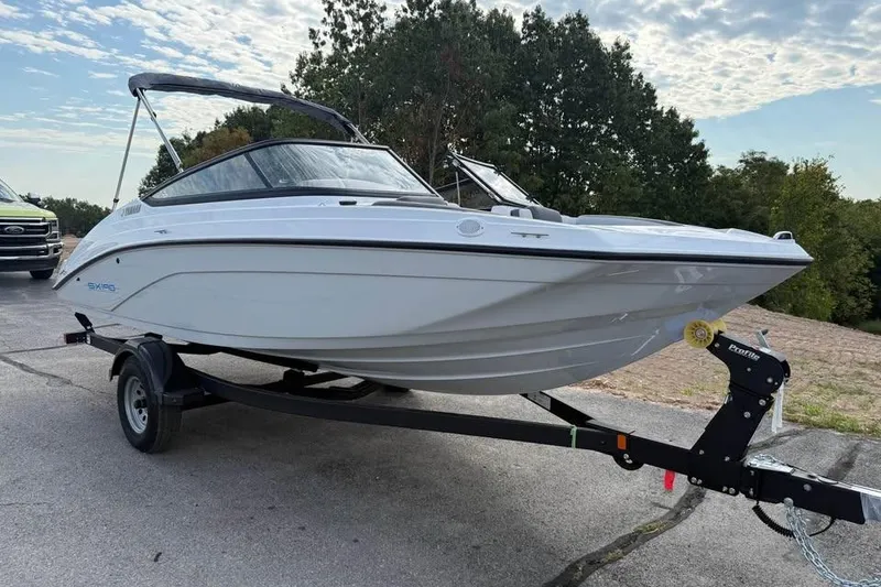 Slide: The Image of 2026 Yamaha Boats SX190 on trailer, parked outdoors under cloudy sky. - 3
