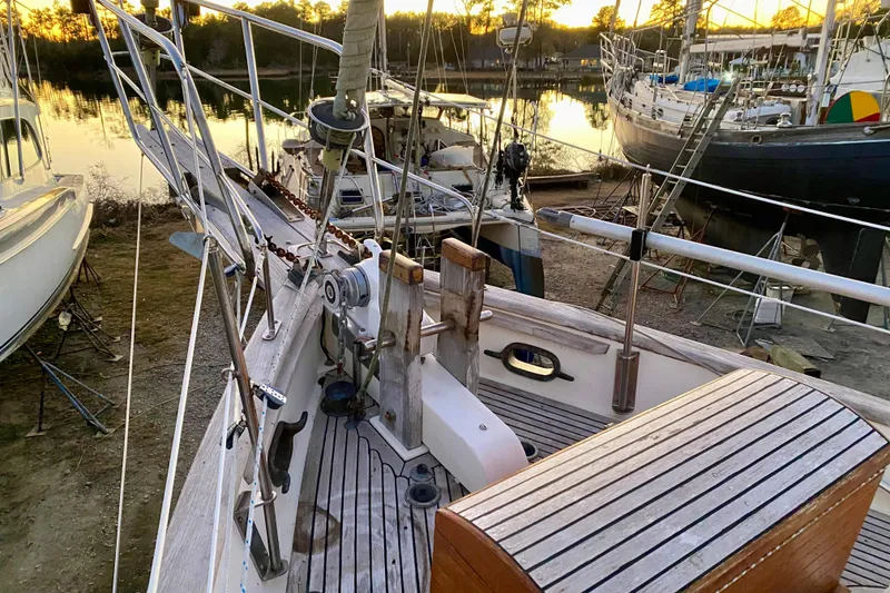 Slide: The Image of 1991 Hans Christian 41 T Molakai sailboat on land, surrounded by other boats at sunset. - 108