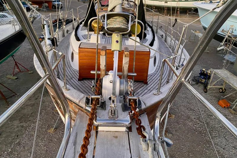 Slide: The Image of 1991 Hans Christian 41 T Molakai sailboat deck with anchor chain and wooden details. - 112