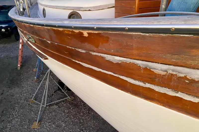Slide: The Image of 1991 Hans Christian 41 T Molakai sailboat with weathered wooden hull on stands. - 115