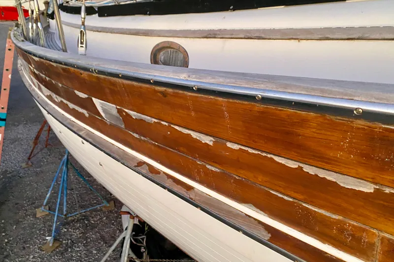 Slide: The Image of 1991 Hans Christian 41 T Molakai sailboat with weathered wooden hull detail. - 116