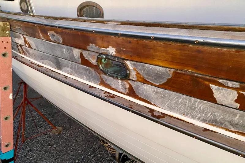 Slide: The Image of Weathered wooden hull of 1991 Hans Christian 41 T Molakai sailboat, showing signs of wear. - 118
