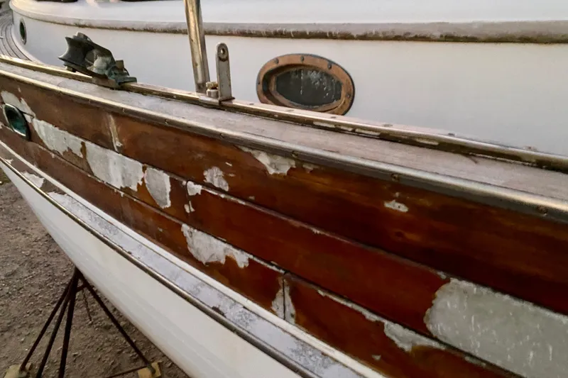 Slide: The Image of Weathered 1991 Hans Christian 41 T Molakai sailboat with peeling paint and wooden details. - 124