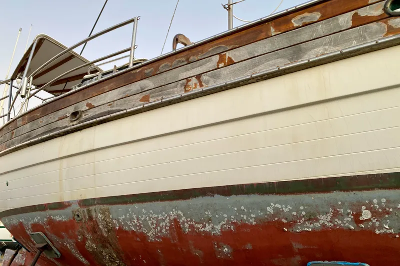 Slide: The Image of 1991 Hans Christian 41 T Molakai sailboat with weathered hull and peeling paint. - 20