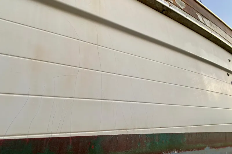 Slide: The Image of Close-up of 1991 Hans Christian 41 T Molakai boat hull with visible wear. - 22