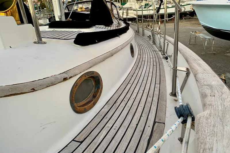Slide: The Image of 1991 Hans Christian 41 T Molakai sailboat deck with wooden details and porthole. - 33