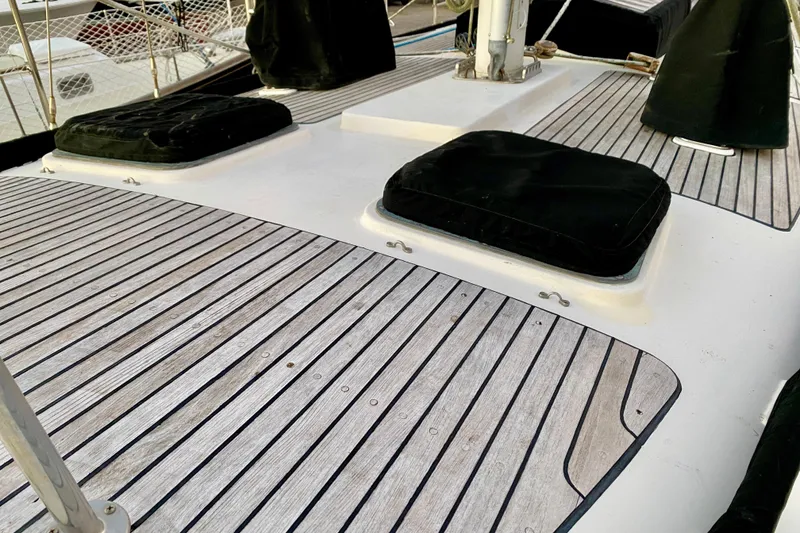 Slide: The Image of Deck of 1991 Hans Christian 41 T Molakai sailboat with wooden slats and black covers. - 34