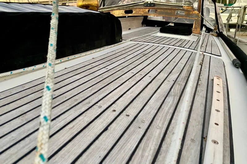 Slide: The Image of Deck of 1991 Hans Christian 41 T Molakai sailboat with wooden planks and rigging. - 42