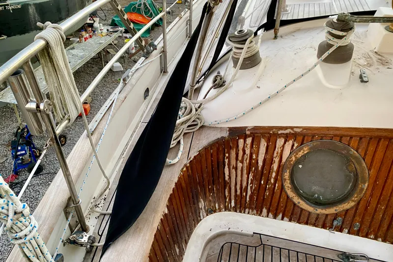 Slide: The Image of 1991 Hans Christian 41 T Molakai sailboat deck with ropes and wooden details. - 49