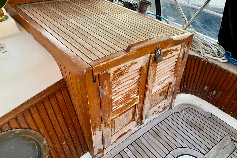 Slide: The Image of Wooden cabin interior of 1991 Hans Christian 41 T Molakai sailboat, showing weathered finish. - 51