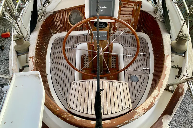 Slide: The Image of Cockpit of 1991 Hans Christian 41 T Molakai sailboat with wooden steering wheel and deck. - 58