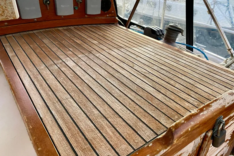 Slide: The Image of Teak deck of 1991 Hans Christian 41 T Molakai sailboat, featuring weathered wood finish. - 69