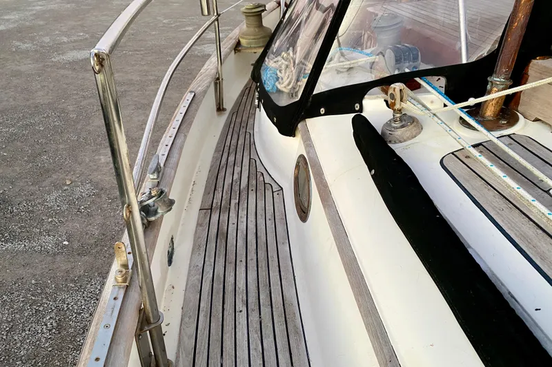 Slide: The Image of Deck view of 1991 Hans Christian 41 T Molakai sailboat, featuring wooden details and railing. - 78