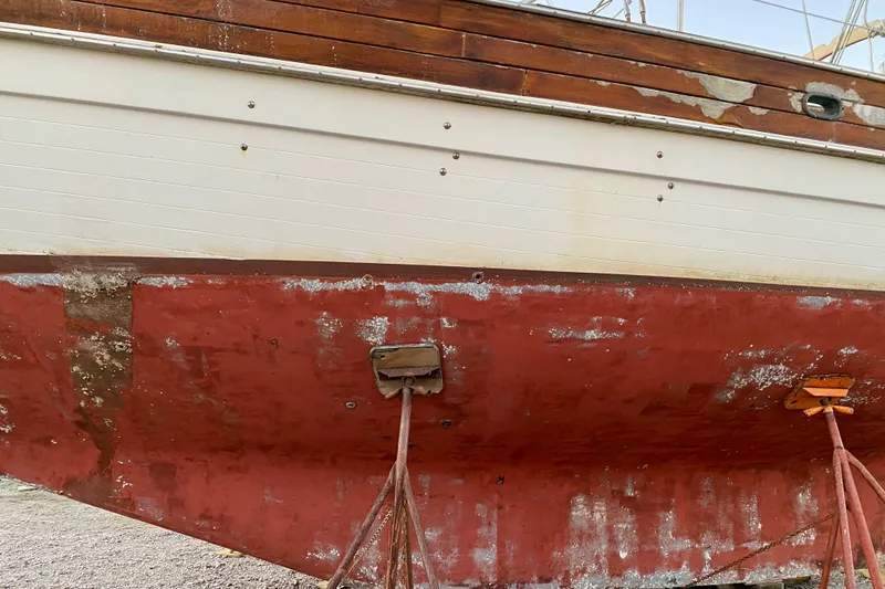 Slide: The Image of 1991 Hans Christian 41 T Molakai sailboat hull with visible wear and supports. - 8