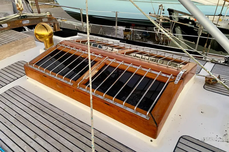 Slide: The Image of Deck of 1991 Hans Christian 41 T Molakai sailboat with wooden hatch and metal bars. - 90