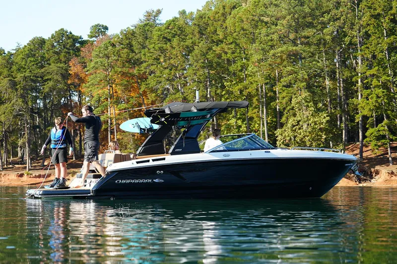 Slide: The Image of Manufacturer Provided Image: 2026 Chaparral GTS 6 boat on a lake with people, surrounded by trees. - 3