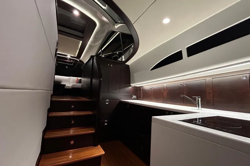 Slide: The Image of Luxurious interior of 2021 Palm Beach Motor Yachts GT60, featuring sleek kitchen and elegant staircase. - 18