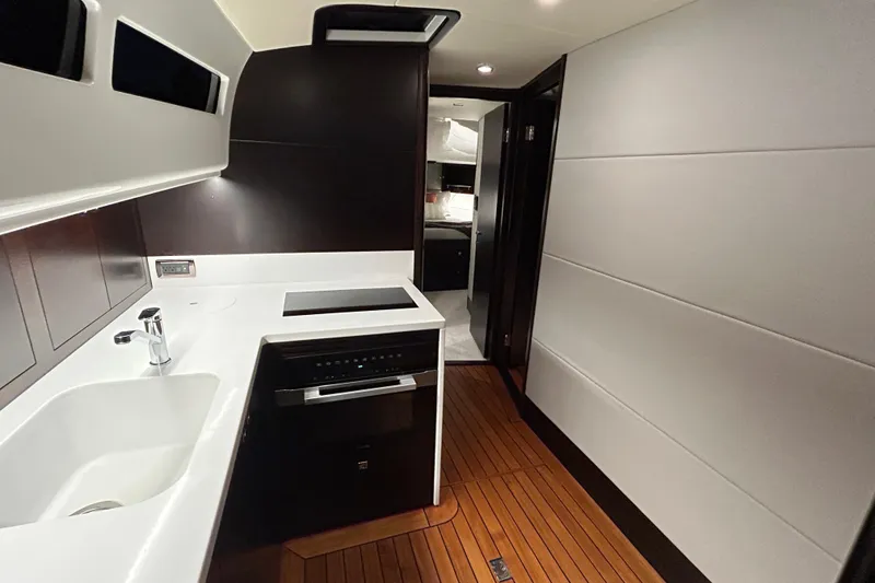 Slide: The Image of 2021 Palm Beach Motor Yachts GT60 interior kitchen with modern design and wood flooring. - 19