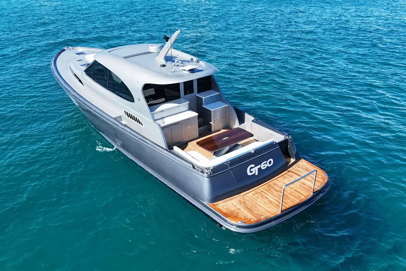 Slide: The Image of 2021 Palm Beach Motor Yachts GT60 cruising on clear blue water. - 2