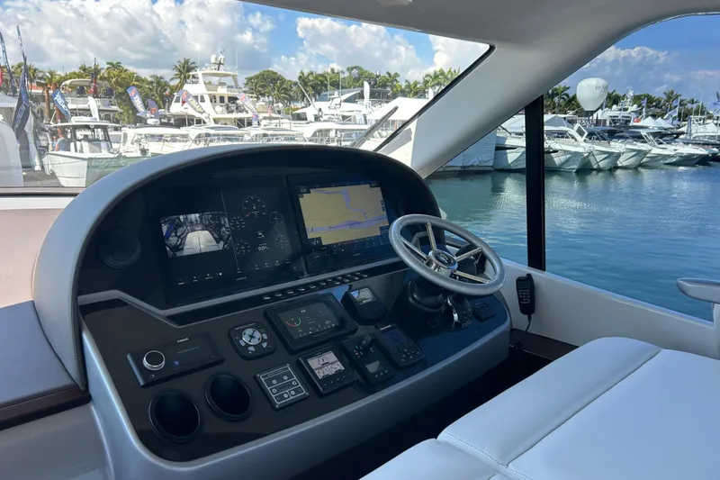 Slide: The Image of Cockpit of 2021 Palm Beach Motor Yachts GT60, featuring advanced navigation controls and luxurious seating. - 4
