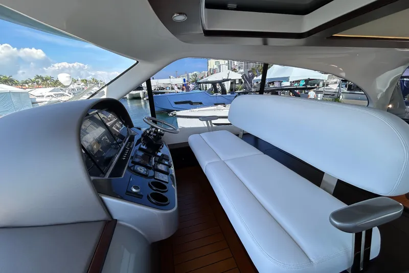 Slide: The Image of 2021 Palm Beach Motor Yachts GT60 interior with sleek helm and white seating. - 6