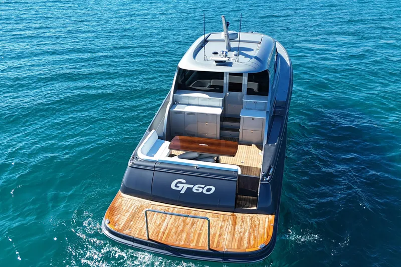 Slide: The Image of 2021 Palm Beach Motor Yachts GT60 on clear blue water, rear view. - 1