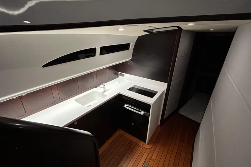 Slide: The Image of Luxurious 2021 Palm Beach Motor Yachts GT60 interior kitchen with modern design and wood flooring. - 15