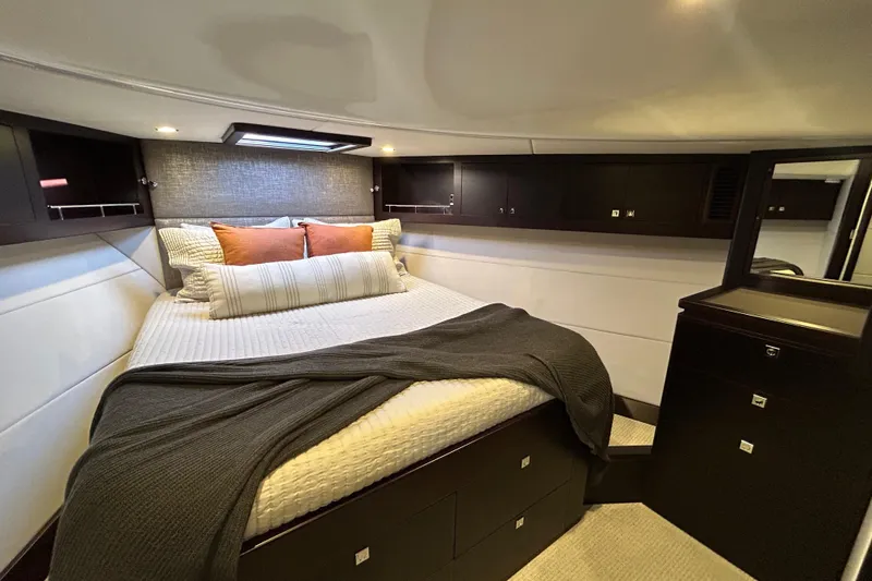 Slide: The Image of Luxurious bedroom interior of 2021 Palm Beach Motor Yachts GT60, featuring elegant bedding and cabinetry. - 23