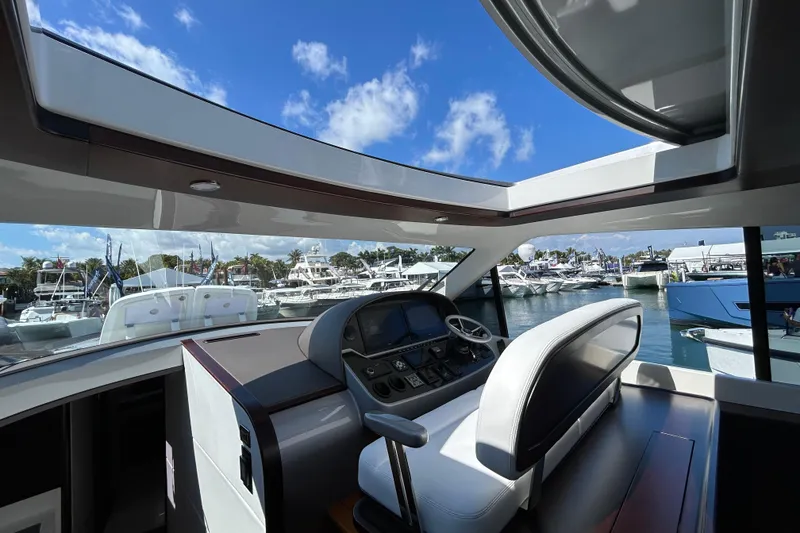 Slide: The Image of Interior view of 2021 Palm Beach Motor Yachts GT60 helm, overlooking marina. - 5
