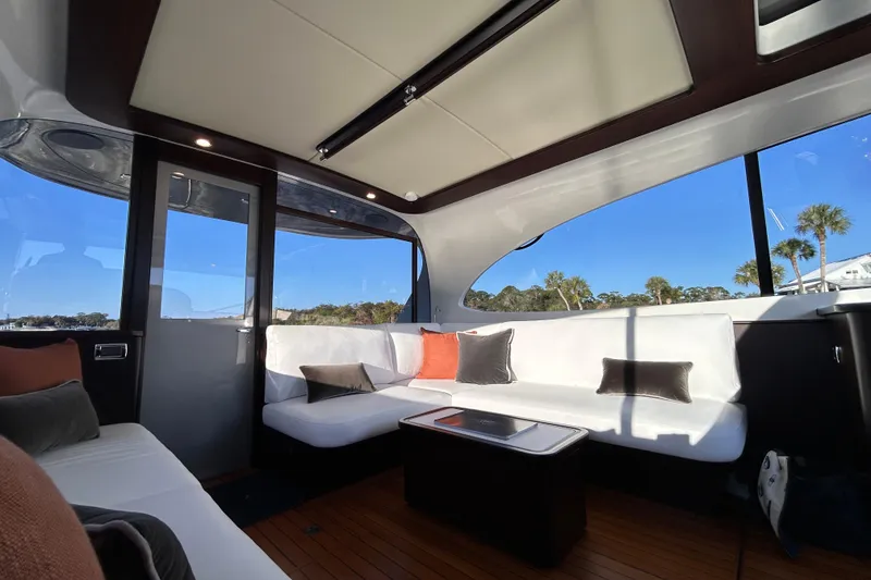 Slide: The Image of Luxurious interior of 2021 Palm Beach Motor Yachts GT60 with elegant seating and panoramic windows. - 9