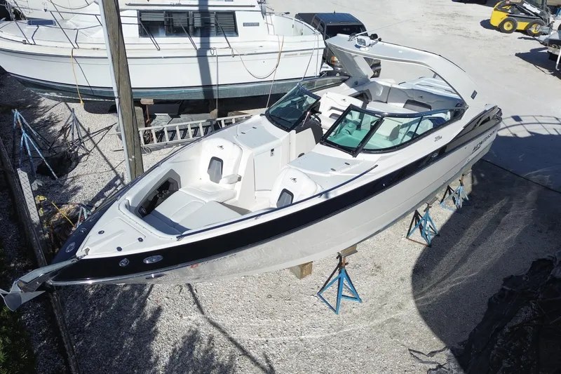 The Image of 2014 Monterey 328SS Super Sport boat on stands in a marina setting. - 0