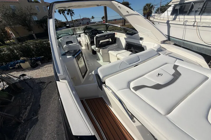 Slide: The Image of 2014 Monterey 328SS Super Sport boat with luxurious white interior and sleek design. - 12