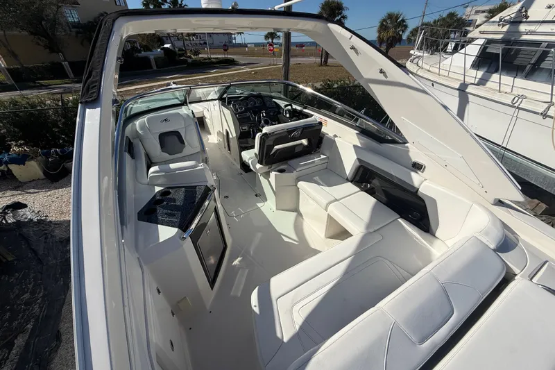 Slide: The Image of 2014 Monterey 328SS Super Sport boat interior with white seating and modern dashboard. - 13