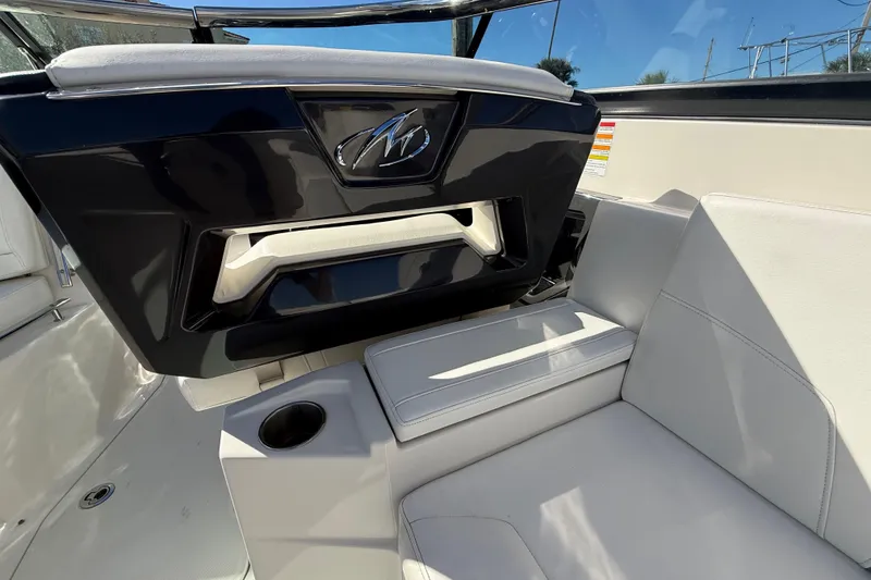 Slide: The Image of 2014 Monterey 328SS Super Sport boat interior with white seating and cup holder. - 21