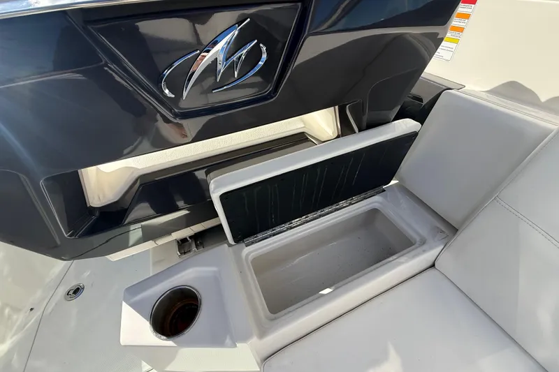 Slide: The Image of 2014 Monterey 328SS Super Sport boat interior with storage compartment and cup holder. - 22