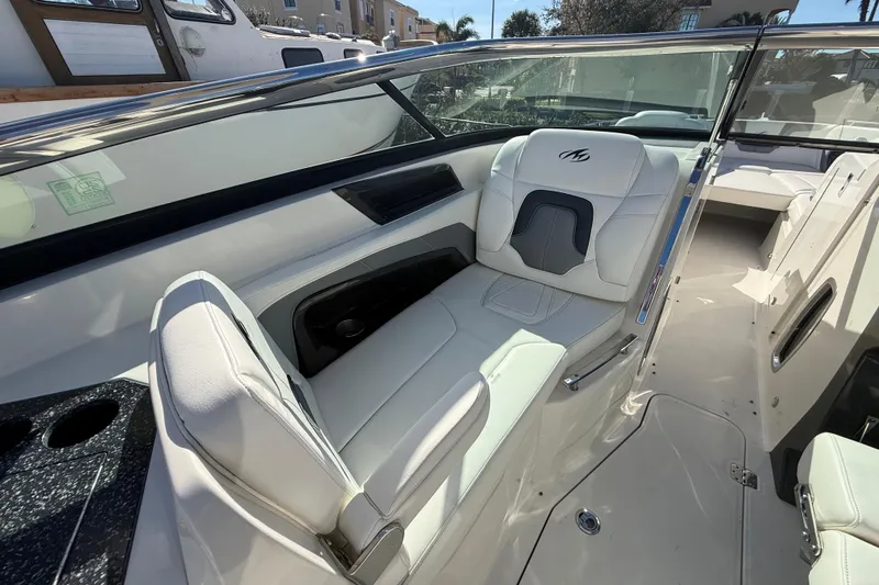 Slide: The Image of 2014 Monterey 328SS Super Sport boat interior with white leather seating and sleek design. - 23