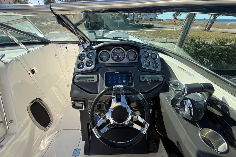 Slide: The Image of 2014 Monterey 328SS Super Sport boat dashboard with steering wheel and control panel. - 29