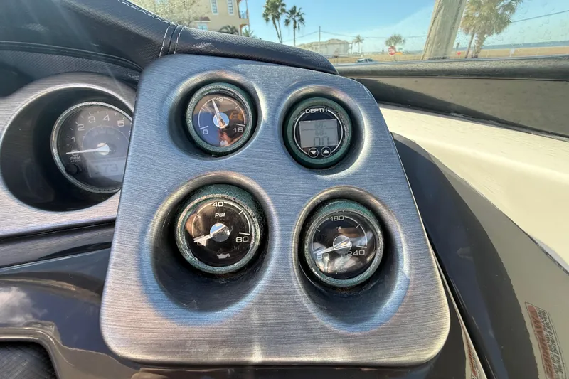 Slide: The Image of Dashboard of a 2014 Monterey 328SS Super Sport boat with gauges and dials. - 38