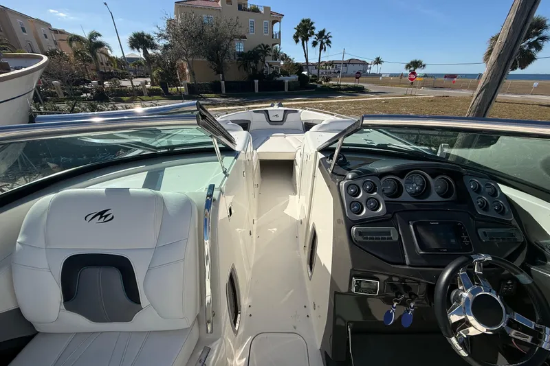 Slide: The Image of Interior of a 2014 Monterey 328SS Super Sport boat with dashboard and seating. - 41