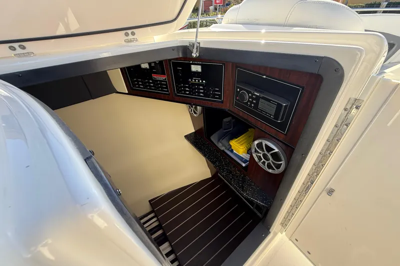 Slide: The Image of 2014 Monterey 328SS Super Sport boat interior with control panel and storage. - 43
