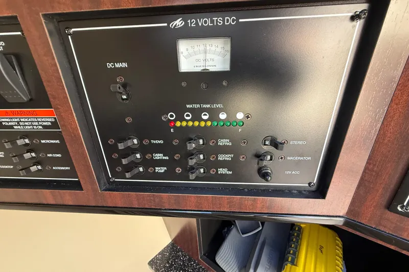 Slide: The Image of Control panel of a 2014 Monterey 328SS Super Sport boat, showing switches and water tank level. - 45