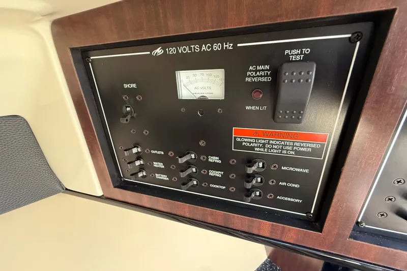 Slide: The Image of Control panel of a 2014 Monterey 328SS Super Sport boat, featuring various switches and warnings. - 46
