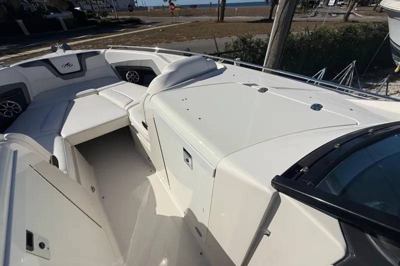 Slide: The Image of 2014 Monterey 328SS Super Sport boat interior with white seating and coastal view. - 49