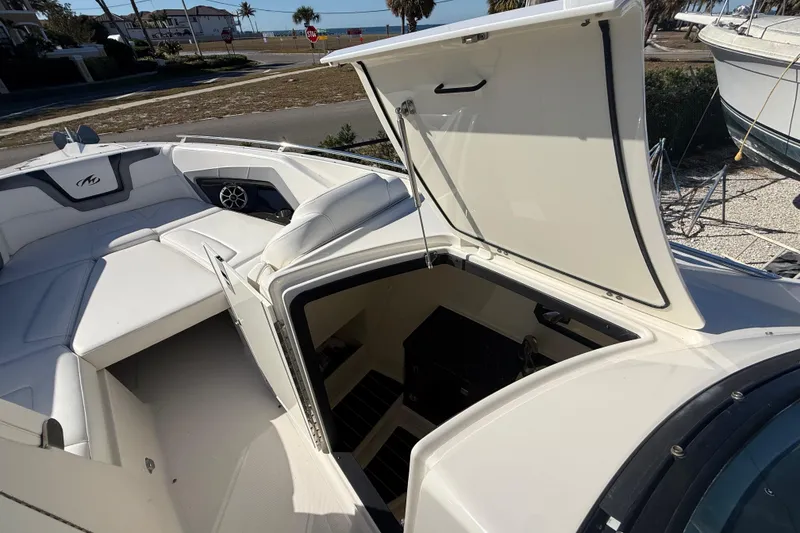 Slide: The Image of 2014 Monterey 328SS Super Sport boat with open storage compartment and seating area. - 50